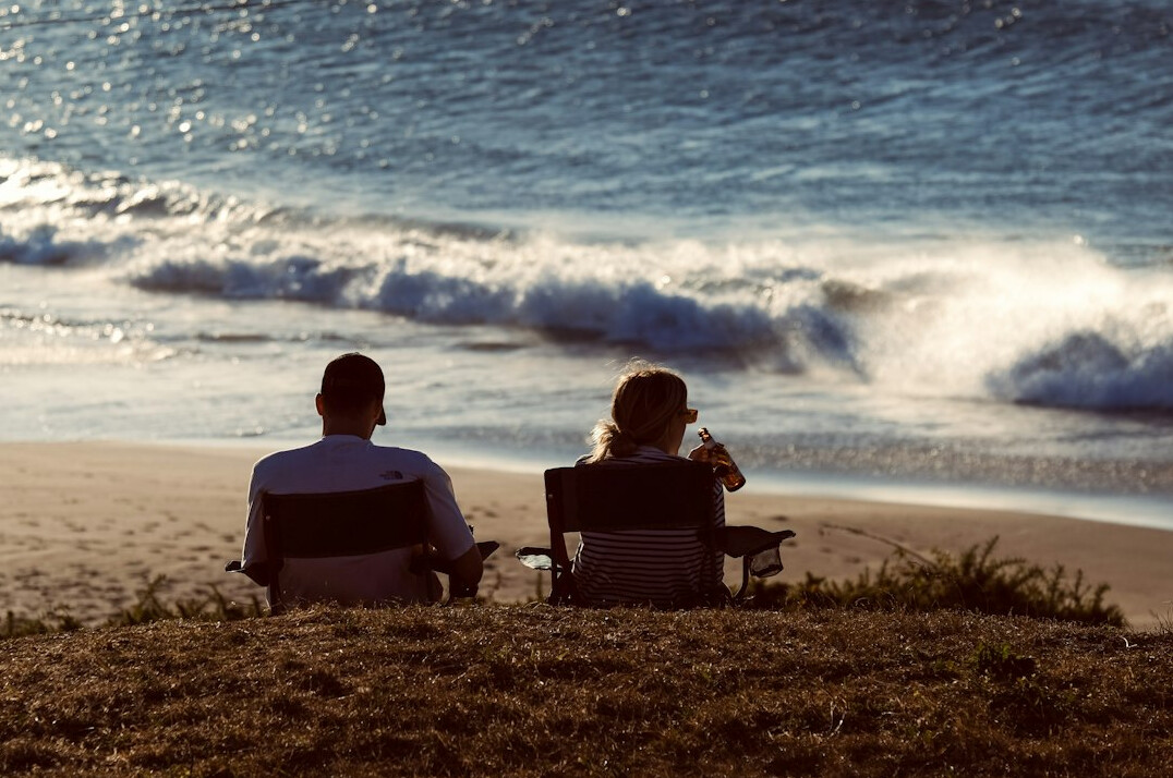 elderly couple relaxing on beach